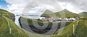 Faroe islands village of Gjogv or Gjov in Danish. Sea-filled gorge on the northeast tip of the island of Eysturoy, in photo