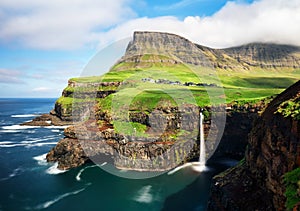 Faroe Islands waterfall alafossur near village Gasadalurron the Island Vagar. Green mountain caost landscape