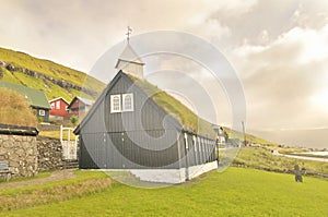 Faroese wooden church standing close to the coast in Kollafjørður.