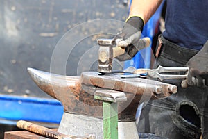 Farrier making a horseshoe