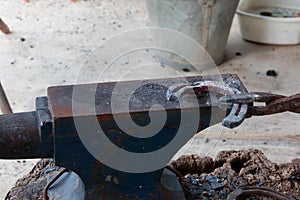 Farrier making horseshoe