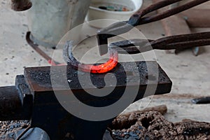 Farrier making horseshoe