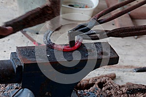 Farrier making horseshoe