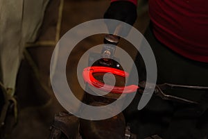 Farrier making horseshoe
