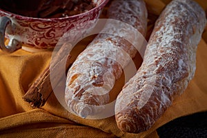 Fartons, typical pastries from Valencia, Spain, with hot chocolate. A sweet breakfast or snack