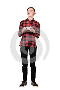 Fascinated teen boy playing video games isolated over white background. Excited adolescent stand all ears holding a joystick