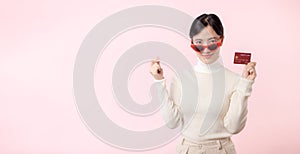 Fascinating fun joyful young woman of Asian ethnicity 20s years old with wear sunglasses wears white shirt hold in hand credit