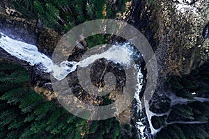 Fascinating high angle shot of the origin of a waterfall on rocks in a forest