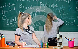 Fascinating science. Educational experiment. Girls classmates study chemistry. Microscope test tubes chemical reactions