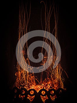 Fascinating spectacle of the bizarre magical dance of sparks and fire in the fireplace insert