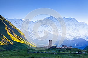 A fascinating view on Ushguli village at the foot of snow-capped Mt. Shkhara. Location place Lamaria Church Jgrag, Georgia, Europe