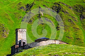 A fascinating view on Ushguli village at the foot of snow-capped Mt. Shkhara. Location place Lamaria Church Jgrag, Upper Svaneti.