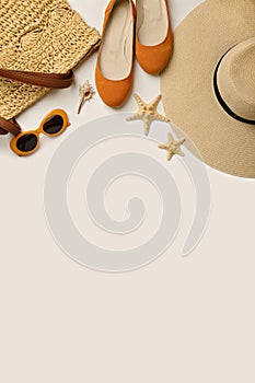 Fashion accessories for the beach - hat, ballet shoes, orange glasses on a white background.