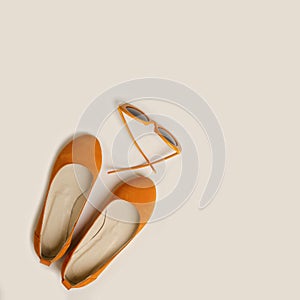 Fashion accessories for the beach - shoes and orange glasses on