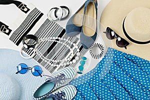 Fashion accessories in black and white and blue colors - hat clothing, shoes and bag, bracelets and glasses.