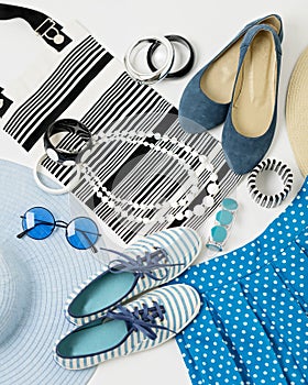 Fashion accessories in black and white and blue colors - hat clothing, shoes and bag, bracelets and glasses.