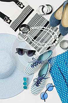 Fashion accessories in black and white and blue colors - hat clothing, shoes and bag, bracelets and glasses.