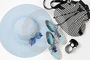 Fashion accessories in blue colors - hat, shoes and bag, bracelets and glasses.