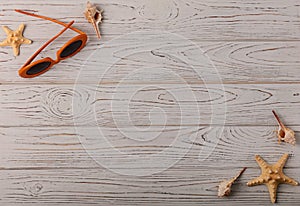 Fashion accessories - glasses orange color on a wooden background.