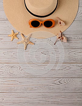 Fashion accessories - hat, glasses orange color on a wooden bac