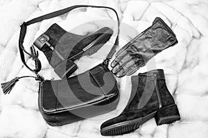 fashion accessory. pair of fashionable leather shoes and bag. heel black boots and gloves