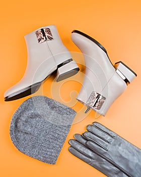 fashion accessory. pair of fashionable leather shoes and hat. beige boots and gloves.