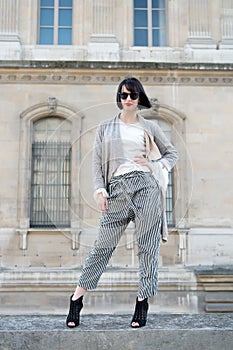 Fashion, accessory, vogue. Sensual woman pose on high heels in paris, france, fashion. Woman with brunette hair, red lips, makeup,