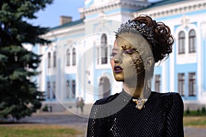 Fashion art Golden skin Woman face portrait at building background