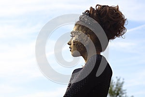 Fashion art Golden skin Woman face portrait at building background