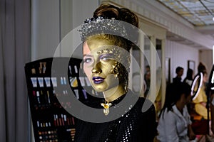 Fashion art Golden skin Woman face portrait at building background