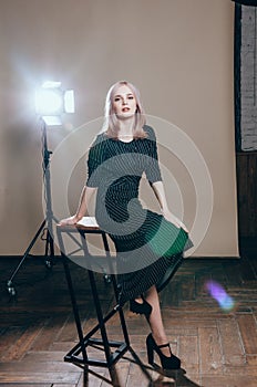 Fashion art portrait of a female model at studio in the light flashes