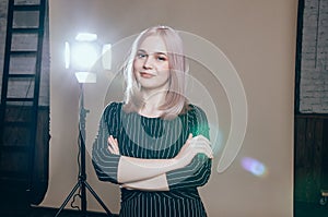 Fashion art portrait of a female model at studio in the light flashes