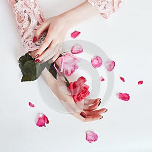 Fashion art portrait woman in summer dress and flowers in her hand with a bright contrasting makeup. Creative beauty photo girls