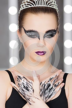 Fashion art studio portrait of beautiful elegant woman in black turtleneck. Hair is collected in high beam. Elegant ballet style