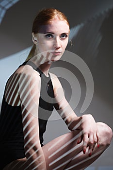 Fashion art studio portrait of elegant naked lady with shadow on her body