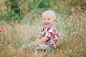 Fashion baby boy walking in grass