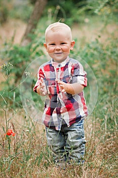 Fashion baby boy walking in grass