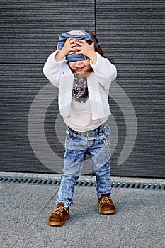 Fashion baby girl hip hop.a little girl in a baseball cap.