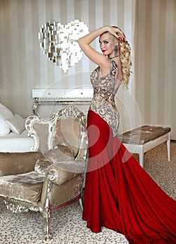 Fashion beautiful blond Girl model with elegant hairstyle in red