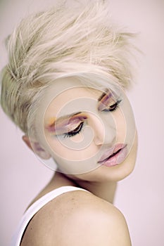 Fashion beautiful blonde woman with short haircut and colorful make up