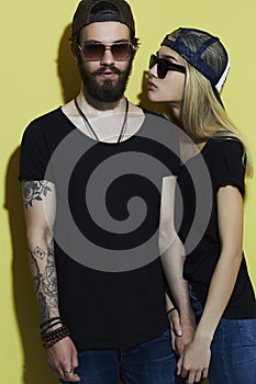 Fashion beautiful couple in hat together. Hipster boy and girl