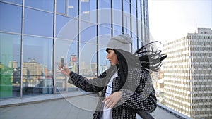 Fashion beautiful hispanic latina woman texting on smartphone in the city drinking latte coffee.