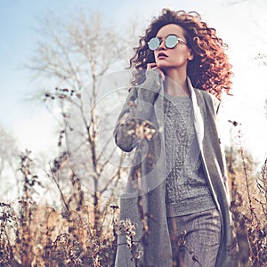 Fashion beautiful lady in autumn landscape