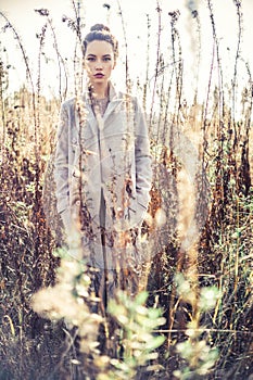 Fashion beautiful lady in autumn landscape