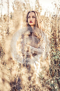 Fashion beautiful lady in autumn landscape