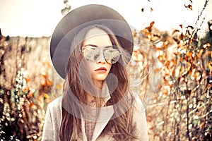 Fashion beautiful lady in autumn landscape