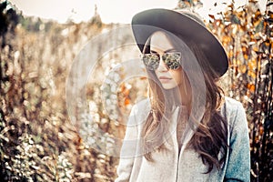 Fashion beautiful lady in autumn landscape