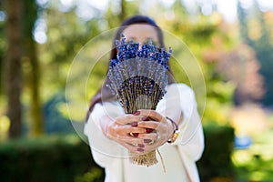 Fashion beautiful woman holding a lavander bouquet