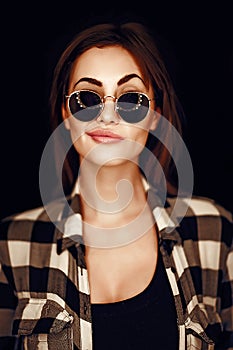 Fashion beauty girl wearing sunglasses, plaid shirt.