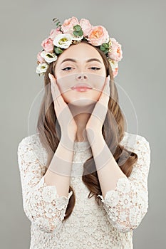 Fashion beauty portrait of cute woman wearing white dress and rose flowers wreath